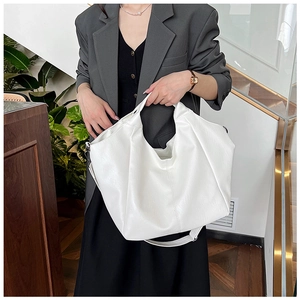 Close-up of a white PU leather hobo tote bag with a soft texture and detachable strap