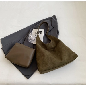 Detail view of olive suede tote bag with inner pouch on a minimalist lifestyle setting