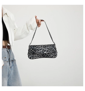 Detailed view of the leopard print baguette bag in structured textured PU leather