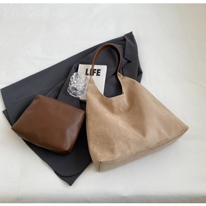 Detail view of suede tote bag set with deep brown leather straps and inner pouch