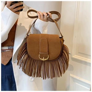 Brown suede saddle bag featuring long fringe tassels and vintage bohemian design details