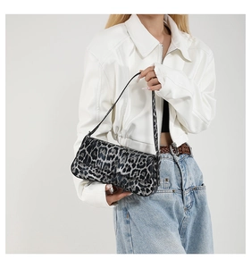 Detailed view of trendy leopard print PU leather shoulder bag on a female model