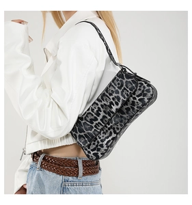 Detail view of the leopard print PU baguette shoulder bag worn with a casual outfit