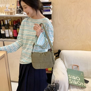 Close-up of military green quilted nylon crossbody bag with adjustable strap and puff texture