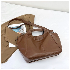 Minimalist brown PU leather tote bag with adjustable strap and dual handles for daily commute
