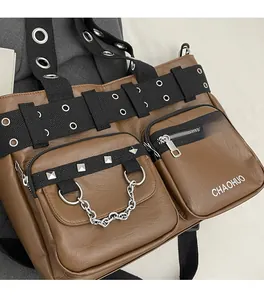 Detail view of brown PU leather shoulder bag featuring metal eyelets and silver chains