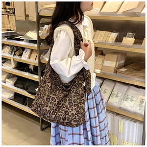 Close-up of large leopard print canvas tote bag with spacious interior and soft fabric