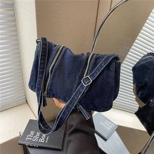Stylish deep blue denim crossbody shoulder bag with silver decorative zippers and adjustable strap