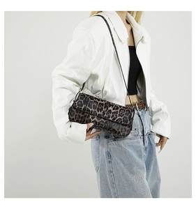 Detailed side view of leopard print PU shoulder bag worn by model in city style