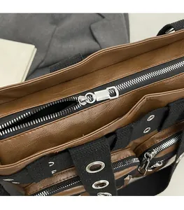 Detailed macro shot of silver metal zipper and brown leather texture on tote bag