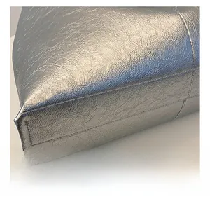 Detailed macro view showing the silver metallic PU leather stitching and fine texture