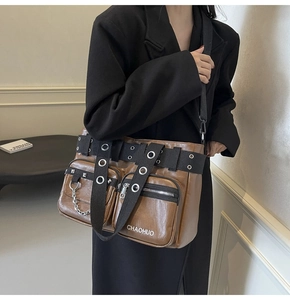 Detail of brown PU crossbody bag featuring metal chains, multi-pockets, and utility straps