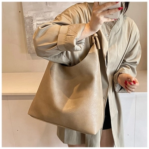 Macro detail of khaki PU leather shoulder bag showing soft pleated texture and minimalist style