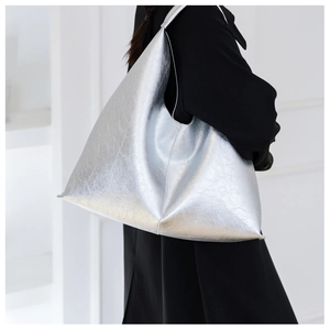 Detail of silver metallic textured PU leather tote bag with unique geometric triangle shape