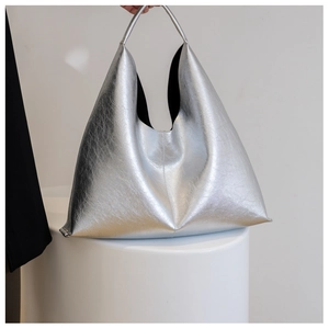 Detailed view of silver metallic pleated PU leather tote bag with unique geometric shape