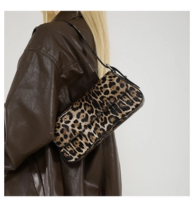 Detail view of stylish leopard print PU shoulder bag worn with dark leather jacket