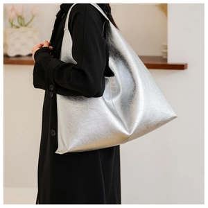 Detailed view of silver PU tote bag showing large capacity and metallic pleated texture