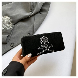 Fashionable black faux suede clutch bag with silver rhinestone skull and crossbones design