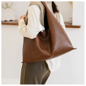Detail of soft brown PU leather hobo bag with vintage texture and large capacity