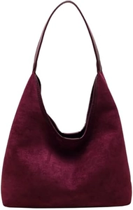 Macro shot of minimalist wine red faux suede hobo bag with vintage shoulder strap texture