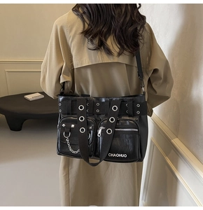 Close-up of black PU leather shoulder bag with multi-pockets and metal chain detail