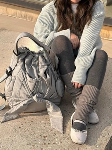 Detail of grey pleated nylon cloud bag featuring large bow and round zipper coin pouch