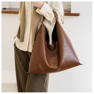 Detailed texture of brown PU leather on large capacity minimalist tote bag for women