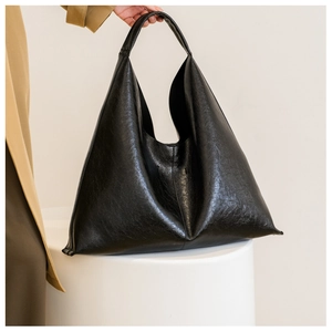 Detail of glossy black PU leather Hobo bag featuring a stylish wrinkled texture and soft drape
