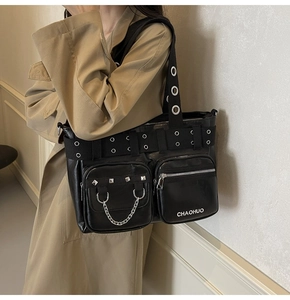 Detail view of black PU leather bag with silver rivets and metal chains decoration