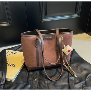 Fashionable brown suede patchwork tote bag with stylish charms for autumn wear