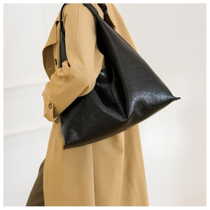 Close-up of black PU leather shoulder bag showing the soft texture and spacious tote style