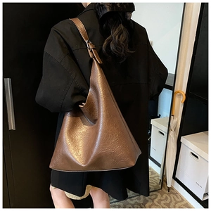 Brown pleated PU leather tote bag shown on model with vintage minimalist style
