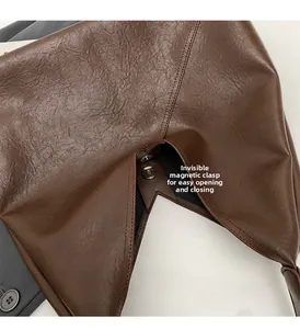 Detail view of the deep brown leather bag featuring an invisible magnetic closure