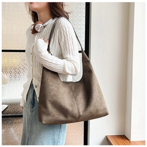 Detail view of coffee-colored frosted PU shoulder bag featuring a vertical seam design