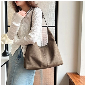 Brown frosted PU leather tote bag shown on shoulder of a model for size perspective