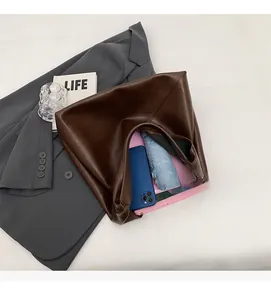 Detail view of large dark brown leather tote bag with ample interior storage space