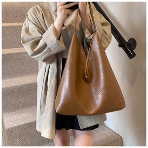 Minimalist brown PU leather tote bag with unique triangular structure and soft pleats