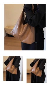 Detail of a brown leather tote bag showing the soft texture and spacious hobo design