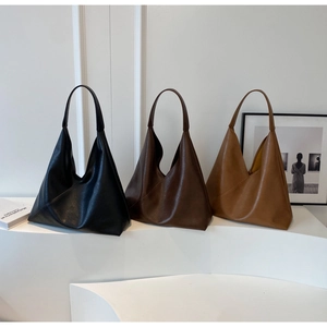 Three minimalist triangular leather tote bags in black, dark coffee, and tan colors