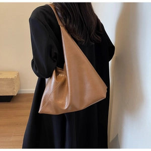 Brown soft faux leather shoulder bag featuring minimalist style and spacious triangular shape