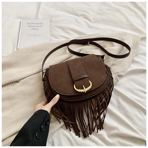 Brown suede saddle bag with vintage fringe tassels and a golden horseshoe buckle