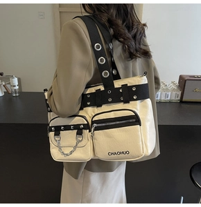 Detailed view of cream PU leather tote bag with punk rivets and wide shoulder strap