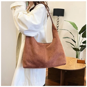 Brown matte PU leather tote bag shown on a model for a stylish casual autumn commute look