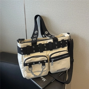 Chic cream PU leather tote bag with industrial metal grommets and black canvas straps
