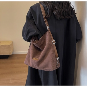 Detail showing the dark brown PU leather side view and adjustable strap on shoulder bag