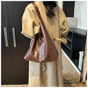 Close-up of a large dark brown PU leather shoulder bag with a minimalist tote design