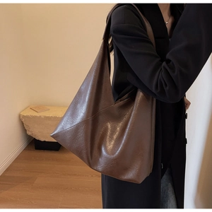 Detailed view of the large dark brown tote bag with premium diagonal stitching and wide strap