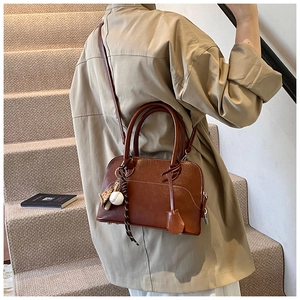 Deep brown PU leather crossbody bag with a decorative baseball theme keychain detail