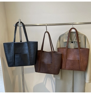 Three vintage PU leather tote bags in black and brown with wrinkled texture detail