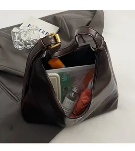 Detail of spacious interior in dark brown hobo bag showing capacity for daily essentials